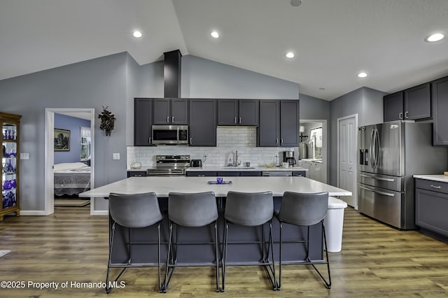 4123 Daisy Dr, Hernando Beach, FL 34607 - kitchen featuring appliances with stainless steel finishes, a sink, light countertops, a kitchen bar, and recessed lighting