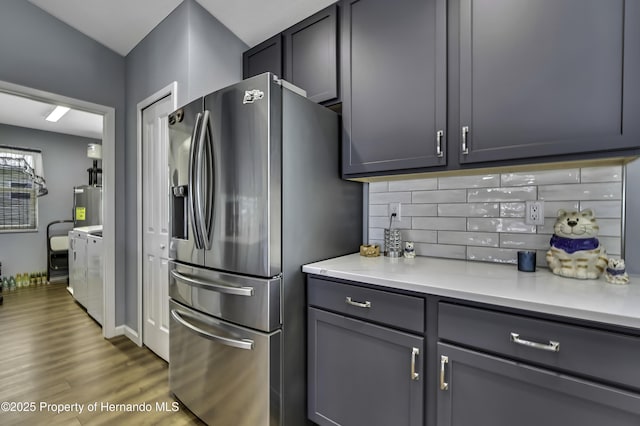 4123 Daisy Dr, Hernando Beach, FL 34607 - kitchen featuring stainless steel fridge with ice dispenser, tasteful backsplash, light countertops, wood finished floors, and water heater