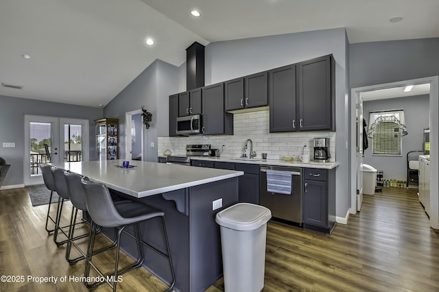 4123 Daisy Dr, Hernando Beach, FL 34607 - kitchen with stainless steel appliances, a sink, lofted ceiling, dark wood-style floors, and backsplash