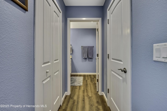 4123 Daisy Dr, Hernando Beach, FL 34607 - hall featuring dark wood-style flooring, baseboards, and a textured wall