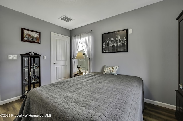 4123 Daisy Dr, Hernando Beach, FL 34607 - bedroom featuring baseboards and dark wood-style flooring