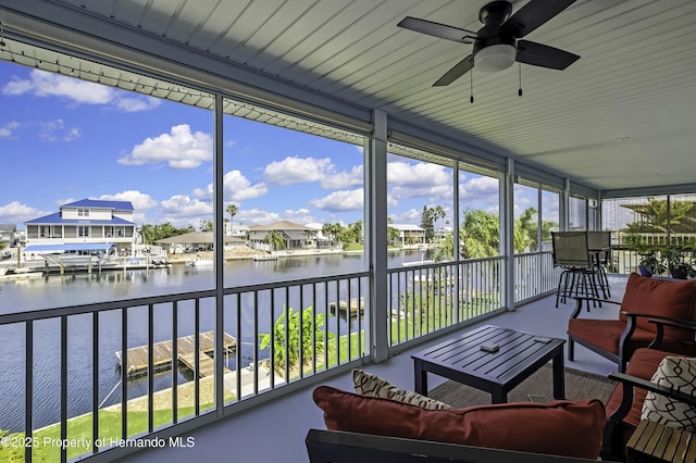 4123 Daisy Dr, Hernando Beach, FL 34607 - sunroom / solarium with a water view, a ceiling fan, an outdoor hangout area, floor to ceiling windows, and a residential view