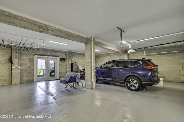 4123 Daisy Dr, Hernando Beach, FL 34607 - garage with french doors, a garage door opener, and concrete block wall