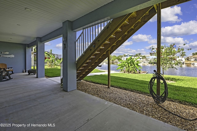 4123 Daisy Dr, Hernando Beach, FL 34607 - view of patio / terrace featuring stairway and a water view