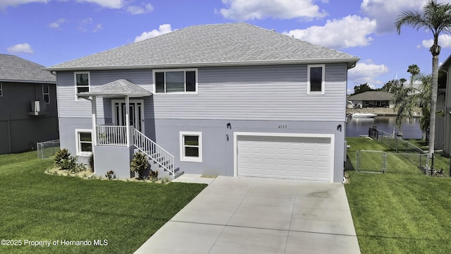 4123 Daisy Dr, Hernando Beach, FL 34607 - view of front of house with concrete driveway, a gate, a garage, a water view, and roof with shingles