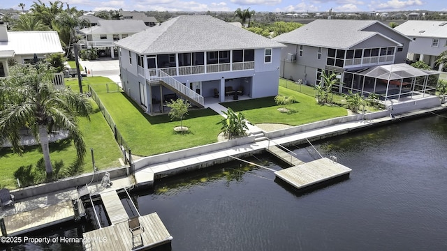 4123 Daisy Dr, Hernando Beach, FL 34607 - back of house featuring a sunroom, a water view, a shingled roof, and a residential view