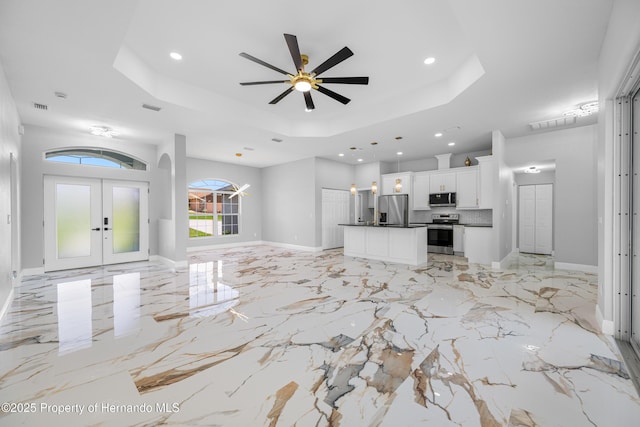 5317 Lydia Ct, Spring Hill, FL 34608 - unfurnished living room with a tray ceiling, french doors, recessed lighting, baseboards, and a ceiling fan