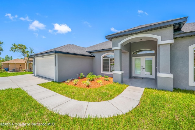 5317 Lydia Ct, Spring Hill, FL 34608 - view of front of property with french doors, stucco siding, an attached garage, driveway, and a front yard