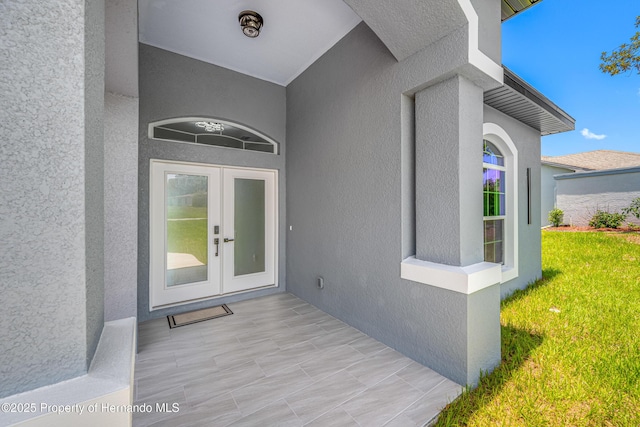 5317 Lydia Ct, Spring Hill, FL 34608 - property entrance featuring french doors, stucco siding, and a yard