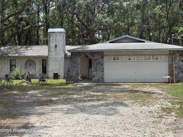 7239 Lykes Dublin Rd, Brooksville, FL 34601 - ranch-style house with driveway, a chimney, an attached garage, and stone siding