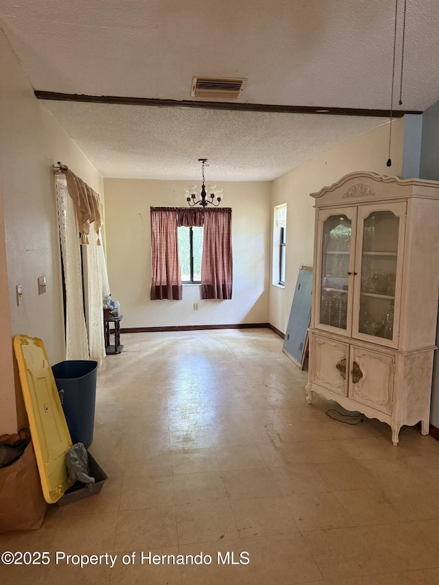 7239 Lykes Dublin Rd, Brooksville, FL 34601 - unfurnished living room with a textured ceiling and a chandelier