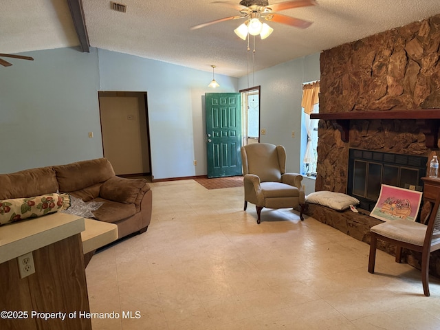 7239 Lykes Dublin Rd, Brooksville, FL 34601 - living area featuring a ceiling fan, a textured ceiling, and a stone fireplace
