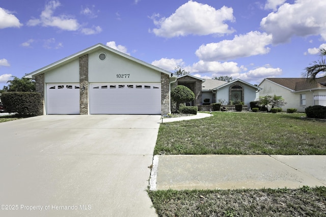 10277 Rosetti Ct, Spring Hill, FL 34608 - ranch-style house featuring an attached garage, driveway, a front lawn, stone siding, and stucco siding