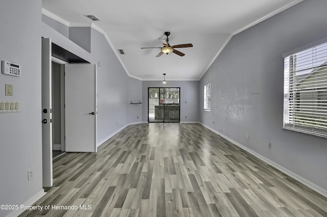 10277 Rosetti Ct, Spring Hill, FL 34608 - unfurnished living room featuring a ceiling fan, ornamental molding, baseboards, light wood-type flooring, and vaulted ceiling