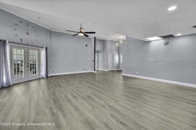 10277 Rosetti Ct, Spring Hill, FL 34608 - unfurnished living room featuring baseboards, recessed lighting, french doors, wood finished floors, and ornamental molding