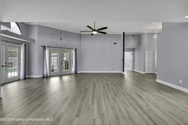 10277 Rosetti Ct, Spring Hill, FL 34608 - unfurnished living room featuring french doors, baseboards, a ceiling fan, a chandelier, and a high ceiling