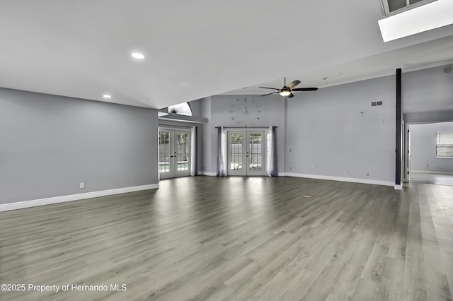 10277 Rosetti Ct, Spring Hill, FL 34608 - unfurnished living room featuring french doors, recessed lighting, baseboards, and wood finished floors