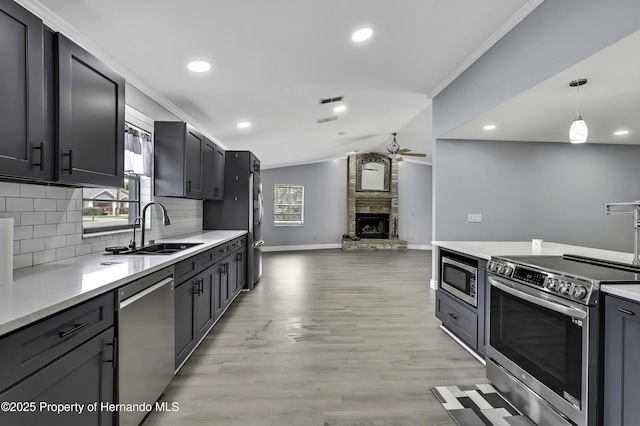 10277 Rosetti Ct, Spring Hill, FL 34608 - kitchen featuring stainless steel appliances, a sink, ornamental molding, decorative backsplash, and a ceiling fan