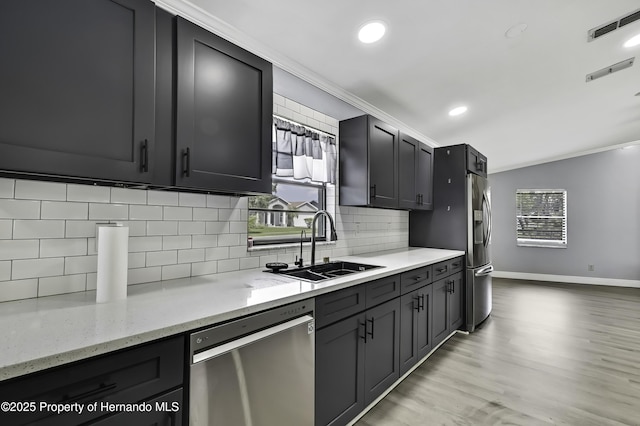 10277 Rosetti Ct, Spring Hill, FL 34608 - kitchen featuring stainless steel appliances, a sink, crown molding, plenty of natural light, and backsplash