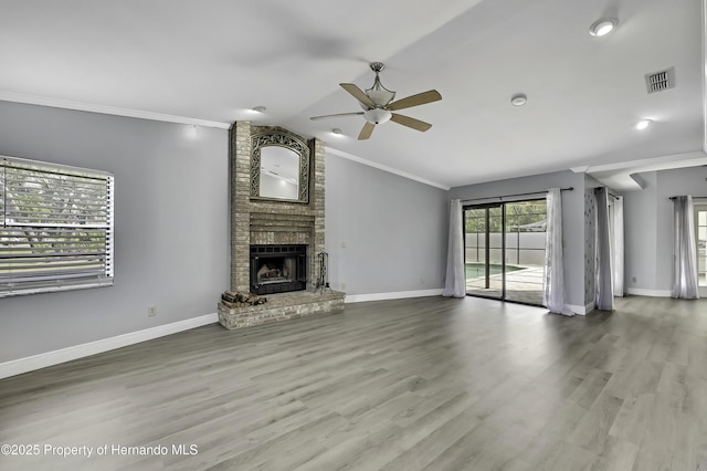 10277 Rosetti Ct, Spring Hill, FL 34608 - unfurnished living room featuring ornamental molding, ceiling fan, lofted ceiling, a fireplace, and baseboards