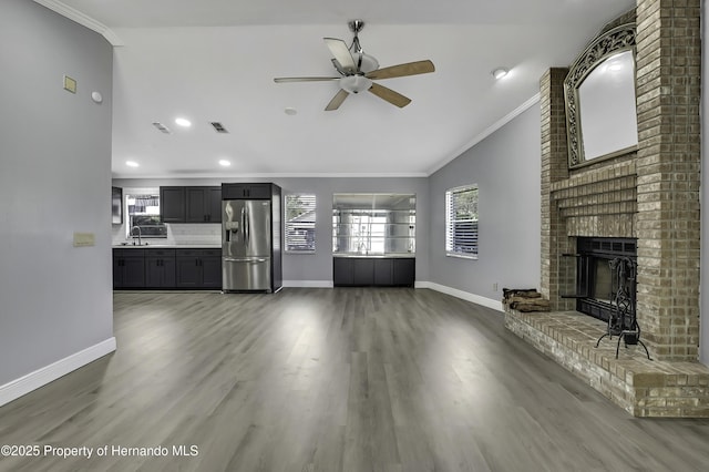 10277 Rosetti Ct, Spring Hill, FL 34608 - unfurnished living room with lofted ceiling, crown molding, healthy amount of natural light, baseboards, and ceiling fan