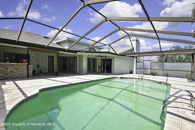 10277 Rosetti Ct, Spring Hill, FL 34608 - outdoor pool with french doors, a patio, and glass enclosure