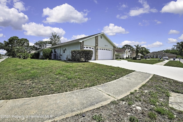 10277 Rosetti Ct, Spring Hill, FL 34608 - view of side of property featuring central air condition unit, concrete driveway, stucco siding, and a yard