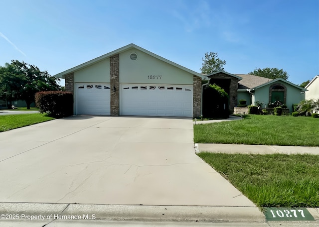 10277 Rosetti Ct, Spring Hill, FL 34608 - ranch-style house featuring an attached garage, concrete driveway, a front lawn, and stucco siding