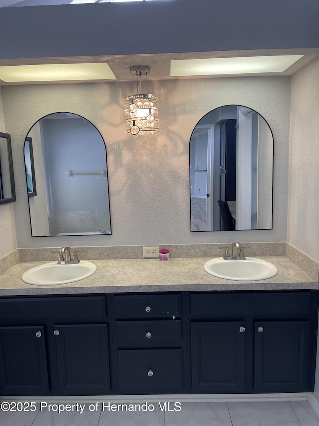 10277 Rosetti Ct, Spring Hill, FL 34608 - bathroom featuring double vanity and tile patterned flooring