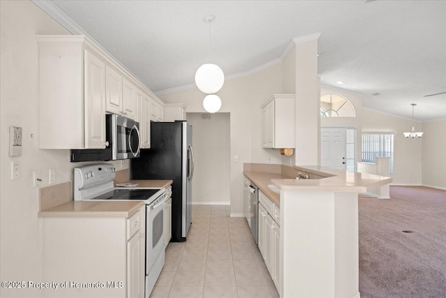 13491 Coronado Dr, Spring Hill, FL 34609 - kitchen with stainless steel appliances, vaulted ceiling, ornamental molding, a textured ceiling, and light countertops