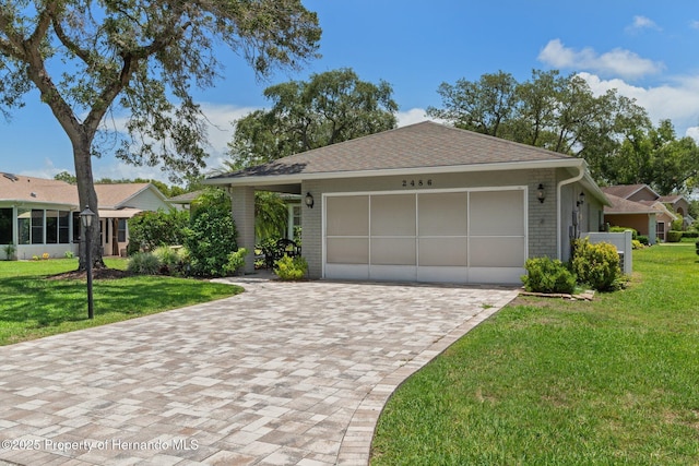 2486 Deer Trail Ln, Spring Hill, FL 34606 - single story home featuring an attached garage, decorative driveway, brick siding, and a front yard
