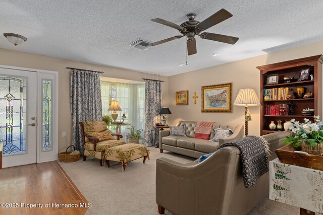 2486 Deer Trail Ln, Spring Hill, FL 34606 - living room with a textured ceiling, a ceiling fan, and wood finished floors