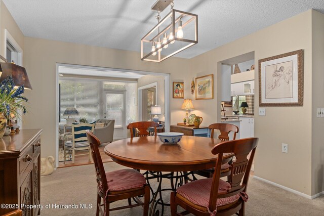 2486 Deer Trail Ln, Spring Hill, FL 34606 - dining room with light carpet, a textured ceiling, and baseboards
