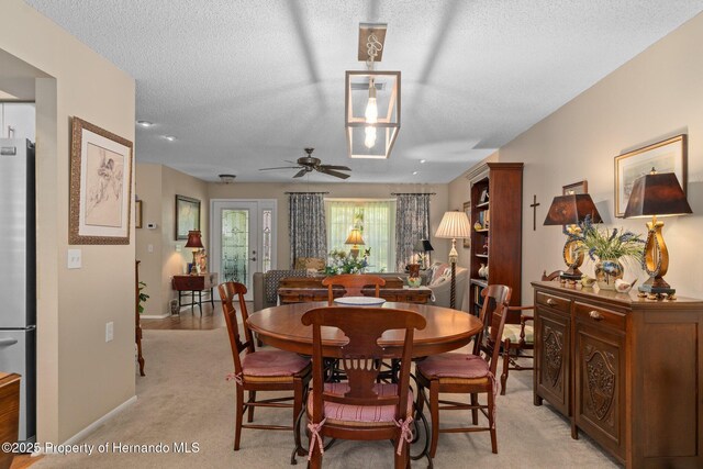 2486 Deer Trail Ln, Spring Hill, FL 34606 - dining space with ceiling fan, a textured ceiling, baseboards, and light carpet