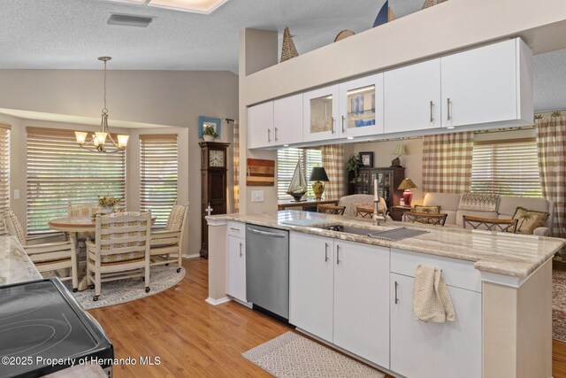 2486 Deer Trail Ln, Spring Hill, FL 34606 - kitchen with dishwasher, lofted ceiling, a chandelier, light wood-style floors, and white cabinets
