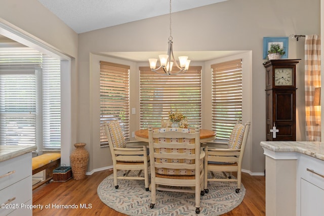 2486 Deer Trail Ln, Spring Hill, FL 34606 - dining room featuring a chandelier, light wood-style floors, vaulted ceiling, and baseboards