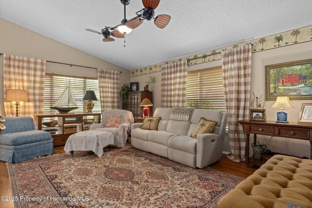 2486 Deer Trail Ln, Spring Hill, FL 34606 - living room featuring lofted ceiling, wood finished floors, a ceiling fan, and a textured ceiling