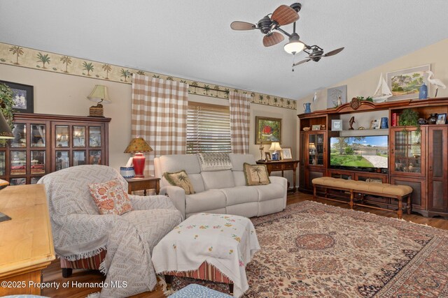 2486 Deer Trail Ln, Spring Hill, FL 34606 - living area featuring wood finished floors, a ceiling fan, lofted ceiling, and a textured ceiling