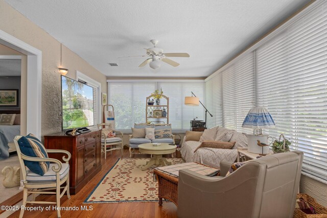 2486 Deer Trail Ln, Spring Hill, FL 34606 - living room featuring ceiling fan, wood finished floors, and a textured ceiling