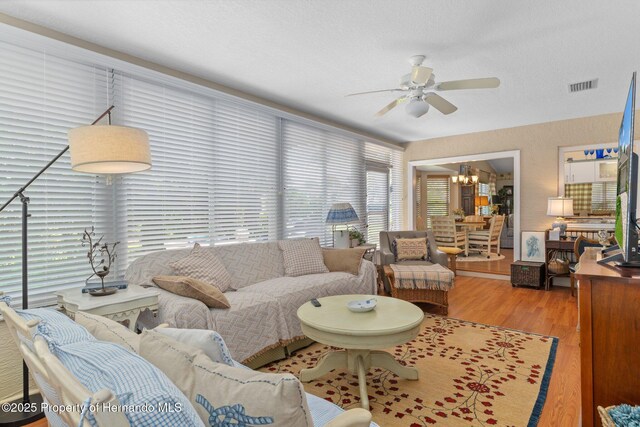 2486 Deer Trail Ln, Spring Hill, FL 34606 - living area with ceiling fan, a chandelier, and wood finished floors