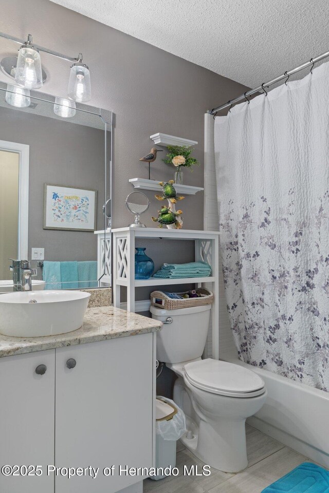 2486 Deer Trail Ln, Spring Hill, FL 34606 - full bath with vanity, toilet, a textured ceiling, and shower / bath combination with curtain
