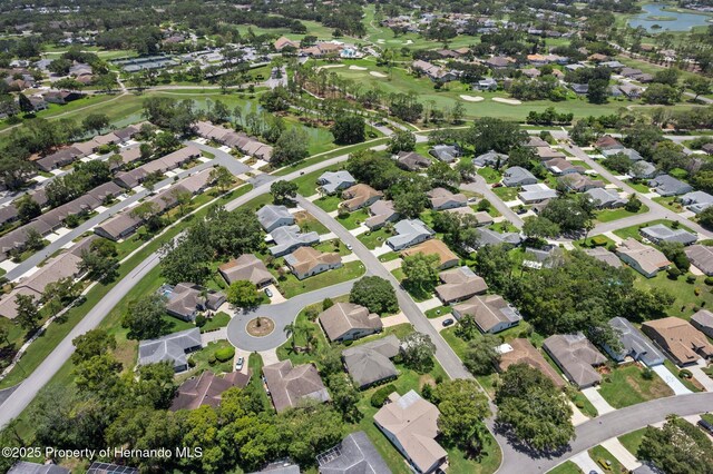 2486 Deer Trail Ln, Spring Hill, FL 34606 - aerial view of property's location featuring nearby suburban area, a large body of water, and a golf course