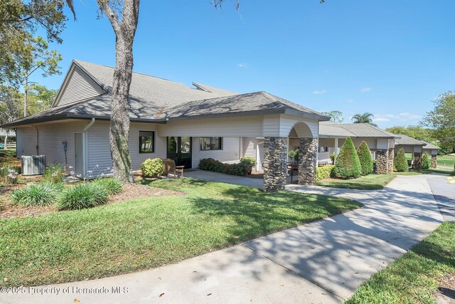 2486 Deer Trail Ln, Spring Hill, FL 34606 - view of front of property with a front yard and central air condition unit