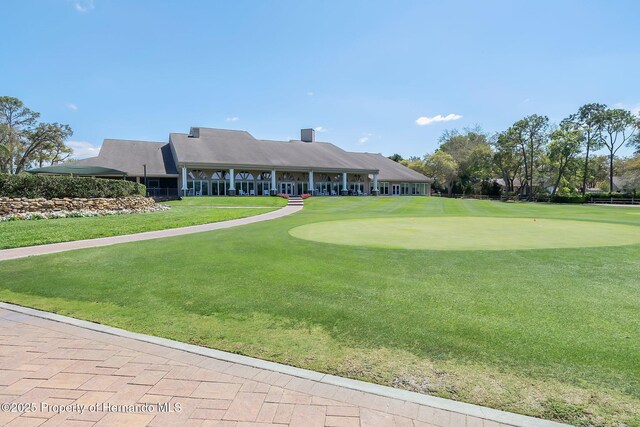 2486 Deer Trail Ln, Spring Hill, FL 34606 - view of property's community with an area to practice putting, a yard, and view of golf course