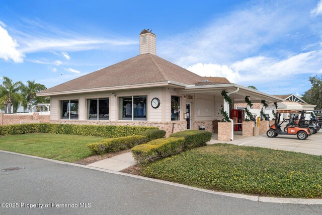 2486 Deer Trail Ln, Spring Hill, FL 34606 - view of front facade featuring a front yard, covered porch, and a chimney