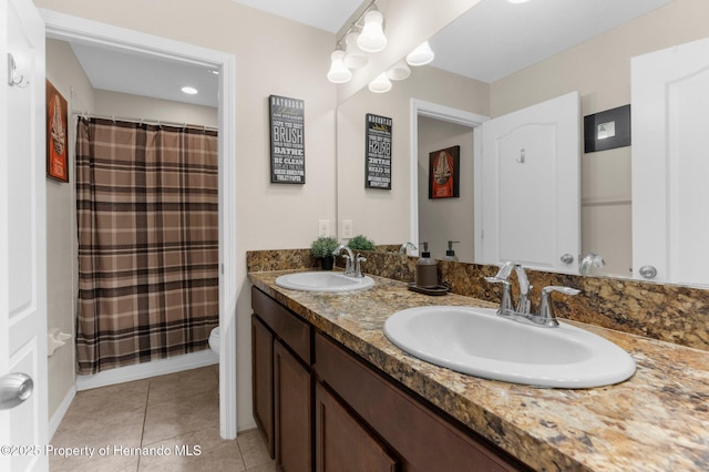 10094 Bankston Dr, Hudson, FL 34667 - bathroom featuring double vanity, tile patterned floors, toilet, and a shower with shower curtain