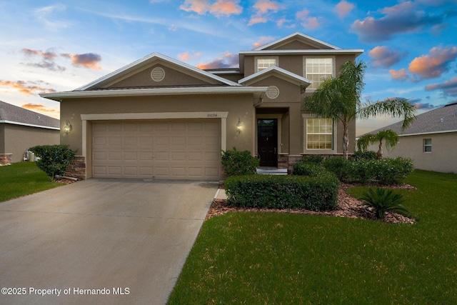 10094 Bankston Dr, Hudson, FL 34667 - traditional-style home featuring concrete driveway, a lawn, stucco siding, an attached garage, and stone siding