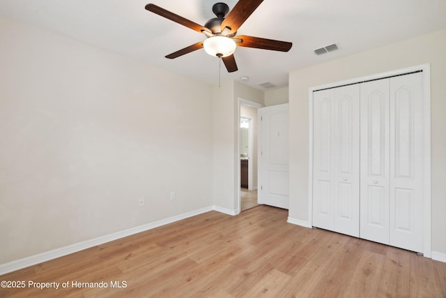 18710 Dobson Dr, Hudson, FL 34667 - unfurnished bedroom with light wood-style flooring, baseboards, a closet, and ceiling fan