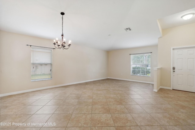 18710 Dobson Dr, Hudson, FL 34667 - unfurnished room featuring a chandelier, light tile patterned floors, and baseboards