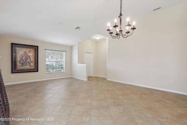 18710 Dobson Dr, Hudson, FL 34667 - empty room featuring a chandelier, light tile patterned floors, vaulted ceiling, and baseboards